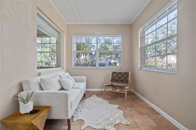 living area with ornamental molding and wooden ceiling