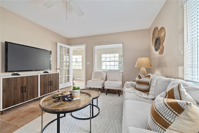 living room featuring light tile patterned floors and ceiling fan