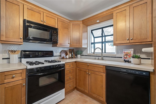 kitchen with black appliances, backsplash, light tile patterned floors, and sink