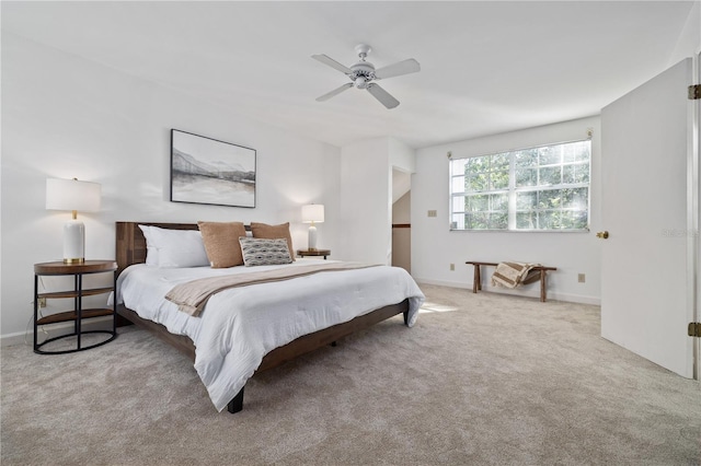 bedroom with ceiling fan and light carpet