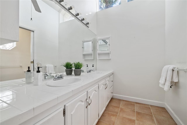 bathroom with tile patterned floors, ceiling fan, and vanity