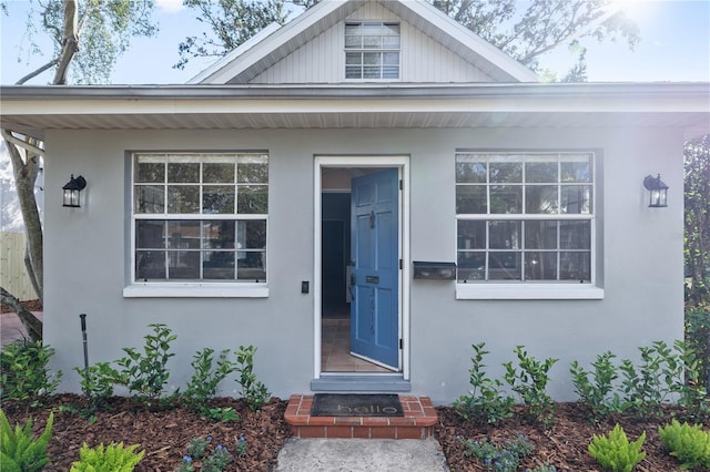 entrance to property with stucco siding