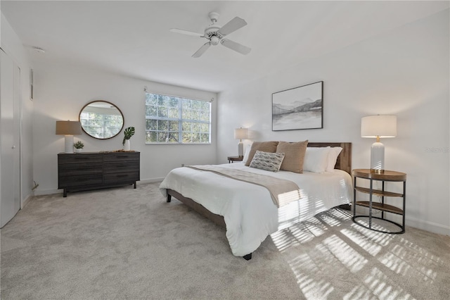 carpeted bedroom with baseboards and a ceiling fan