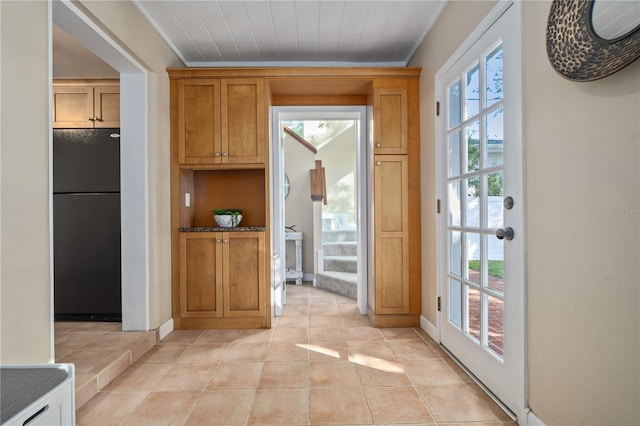 entryway with plenty of natural light, light tile patterned flooring, and stairway