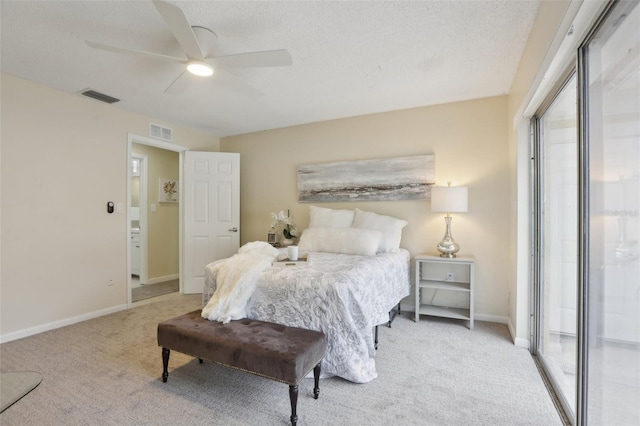 bedroom with light carpet, a textured ceiling, and ceiling fan