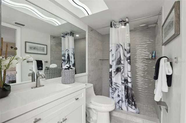 bathroom with curtained shower, vanity, and toilet