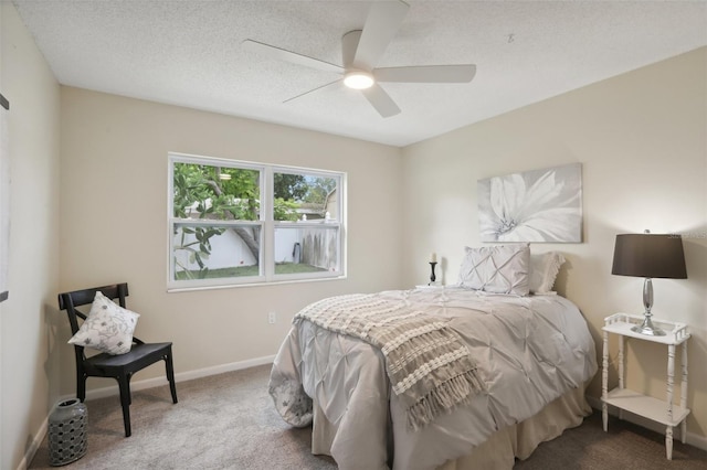 carpeted bedroom featuring a textured ceiling and ceiling fan