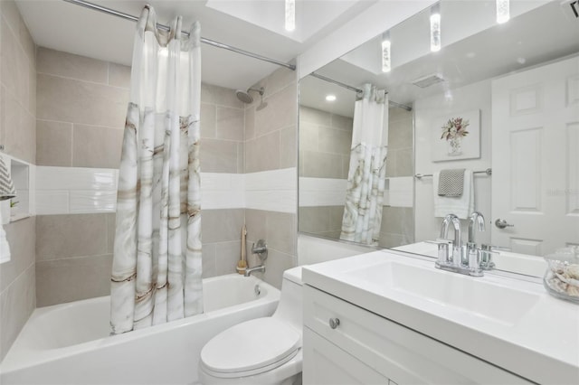 full bathroom with vanity, shower / bath combo, and toilet