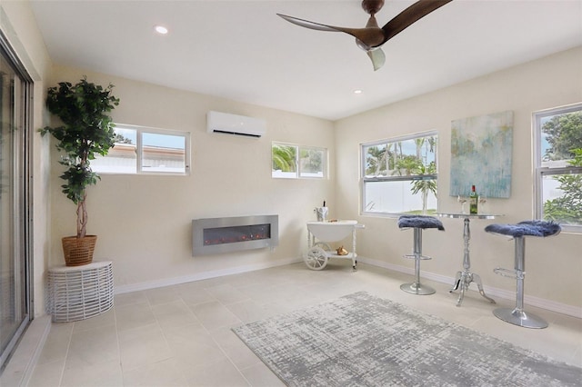 sitting room featuring an AC wall unit, ceiling fan, and light tile patterned flooring