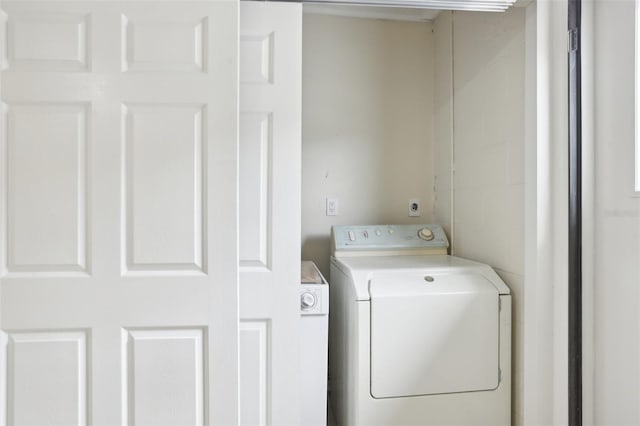 clothes washing area featuring washer / clothes dryer