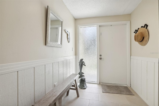 interior space with light tile patterned flooring and a textured ceiling