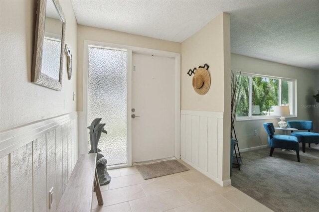 tiled entrance foyer featuring a textured ceiling