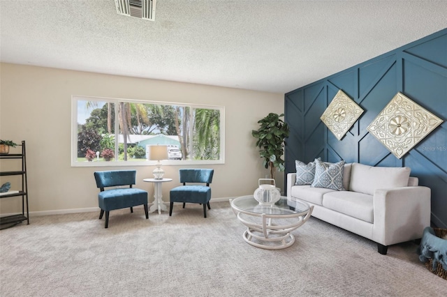 living room with carpet flooring and a textured ceiling