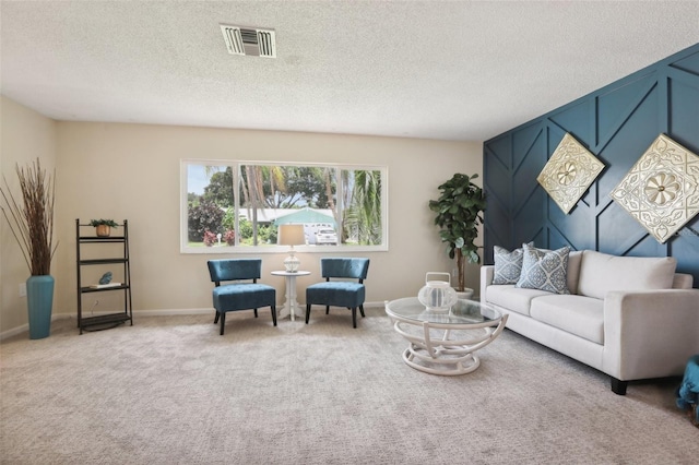 living room featuring light colored carpet and a textured ceiling