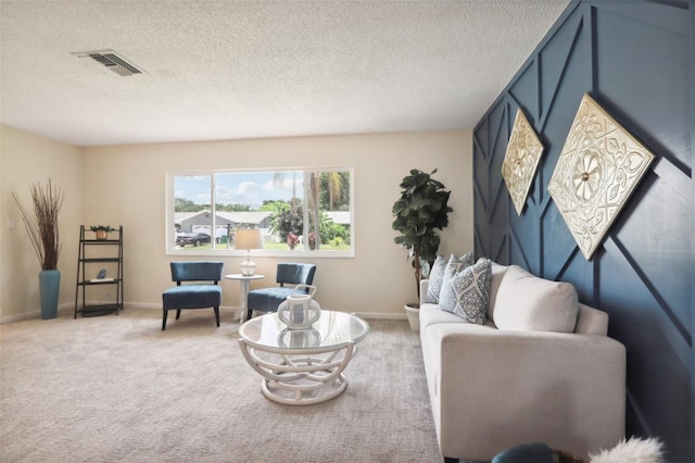 living room featuring carpet floors and a textured ceiling