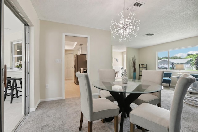 carpeted dining space featuring a textured ceiling and an inviting chandelier