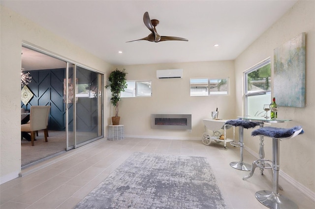 interior space featuring a wall unit AC, ceiling fan, and light tile patterned floors