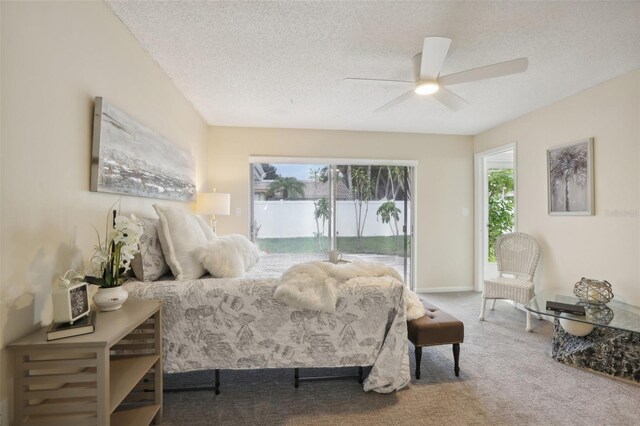 carpeted bedroom with ceiling fan and a textured ceiling