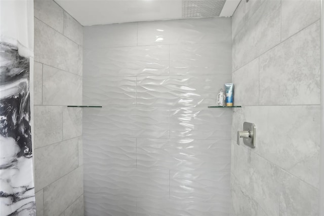 bathroom with tiled shower