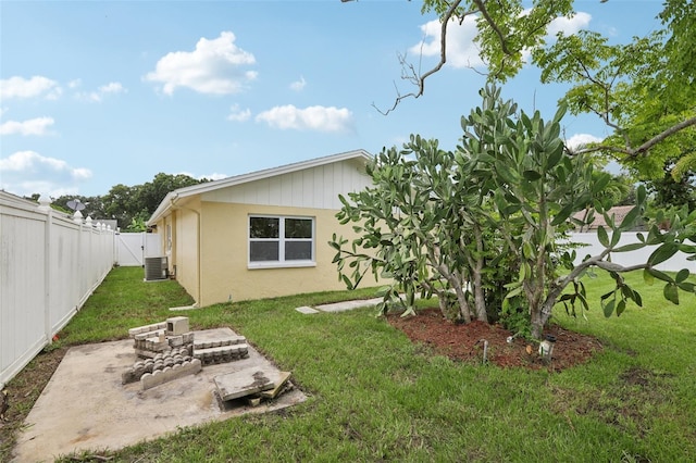 rear view of property with a yard and cooling unit