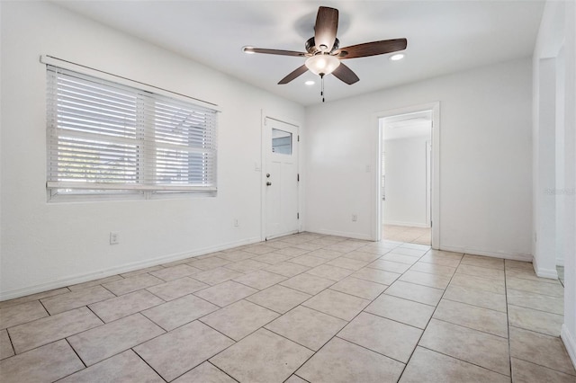 empty room featuring ceiling fan and light tile patterned floors