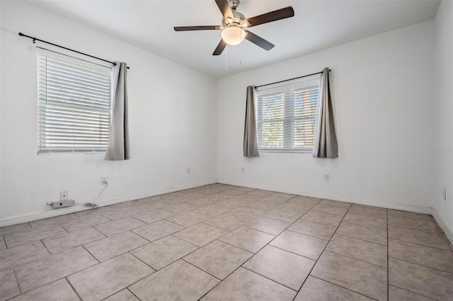 unfurnished room with ceiling fan and light tile patterned floors