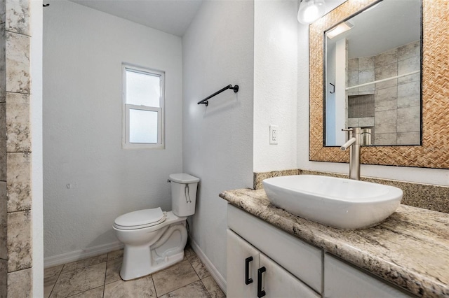 bathroom with tile patterned flooring, vanity, toilet, and a shower