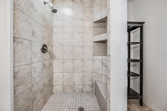 bathroom featuring a tile shower