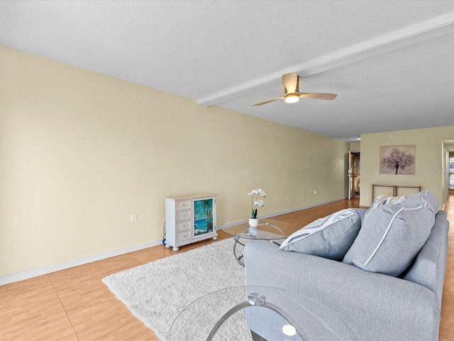 living room with beam ceiling, ceiling fan, and hardwood / wood-style floors