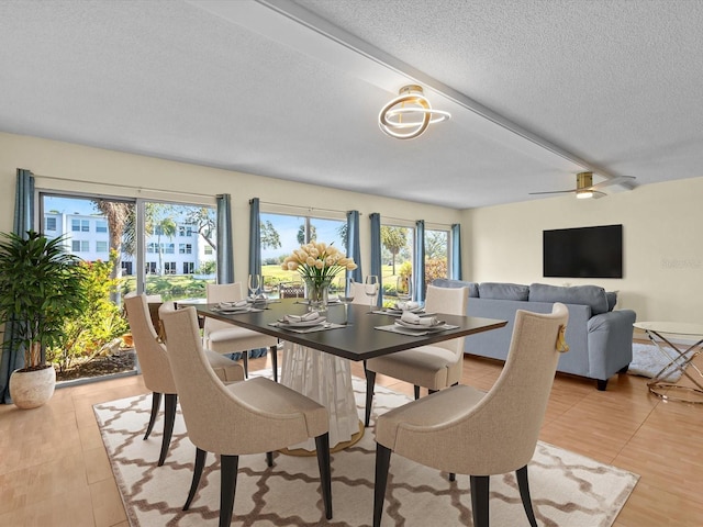 dining room featuring ceiling fan and a textured ceiling