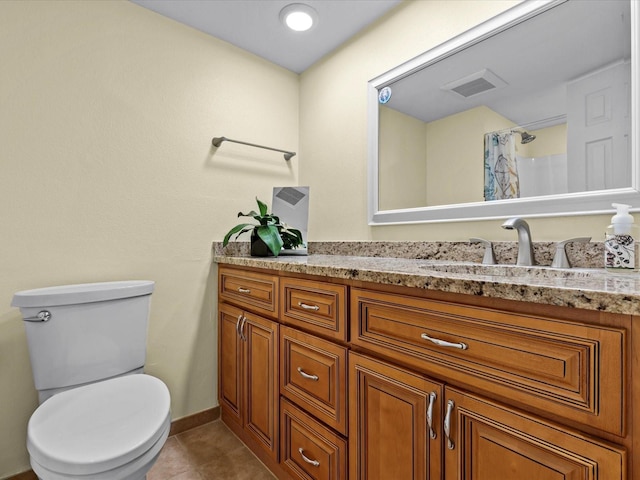 bathroom featuring tile patterned flooring, vanity, toilet, and curtained shower