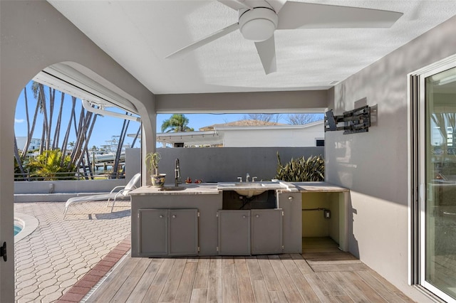 view of patio with sink and ceiling fan