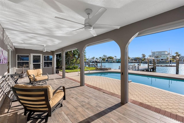 view of swimming pool with a boat dock and a water view