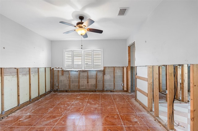 tiled empty room with ceiling fan