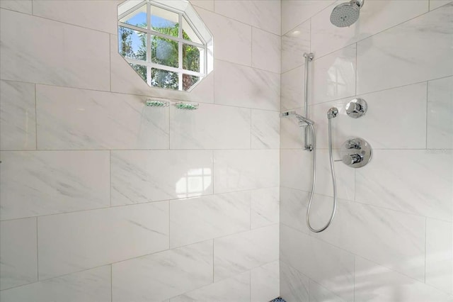 bathroom with a tile shower