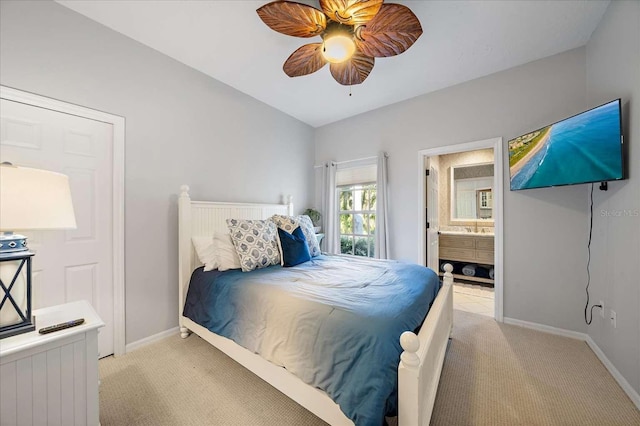 carpeted bedroom featuring ceiling fan and connected bathroom