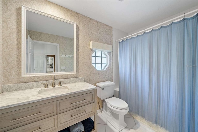 bathroom featuring vanity, toilet, and walk in shower