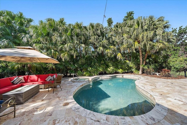 view of pool featuring an outdoor living space, a patio, and an in ground hot tub