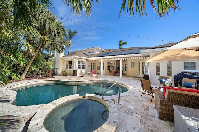 view of pool featuring an in ground hot tub, a patio, and grilling area