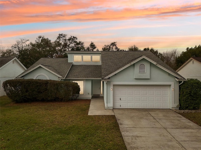 view of front of home featuring a garage and a lawn