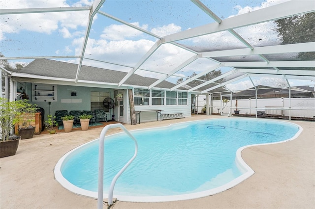 view of swimming pool featuring a patio area and a lanai