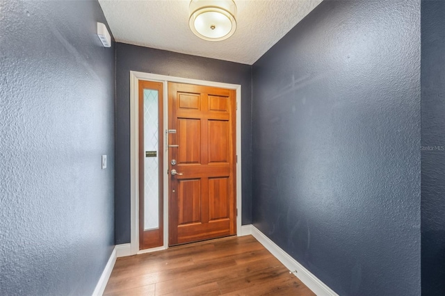 doorway to outside featuring hardwood / wood-style floors and a textured ceiling