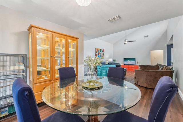 dining space with wood-type flooring, ceiling fan, and lofted ceiling