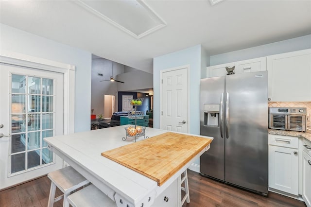 kitchen with tasteful backsplash, white cabinets, stainless steel fridge with ice dispenser, a center island, and dark hardwood / wood-style floors