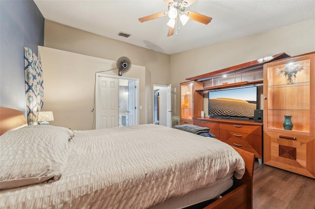 bedroom with ceiling fan and dark wood-type flooring