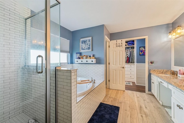 bathroom with vanity, separate shower and tub, and wood-type flooring