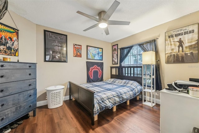 bedroom with dark hardwood / wood-style floors and ceiling fan