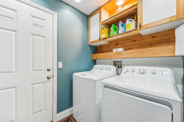 laundry room with cabinets and washer and dryer