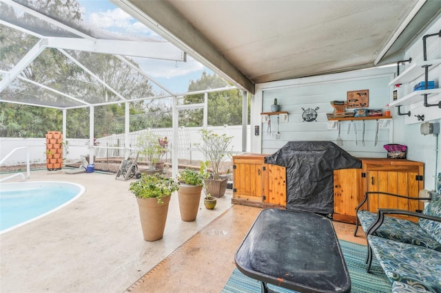 view of patio / terrace with glass enclosure, a grill, and a pool