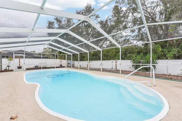 view of swimming pool featuring a patio and a lanai